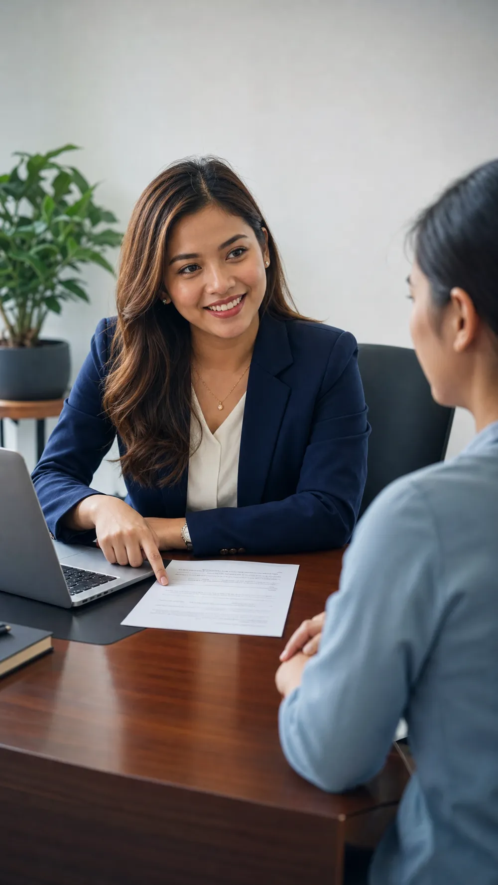 A Visa Alliance Philippines consultant reviewing a visa document with a client across a desk